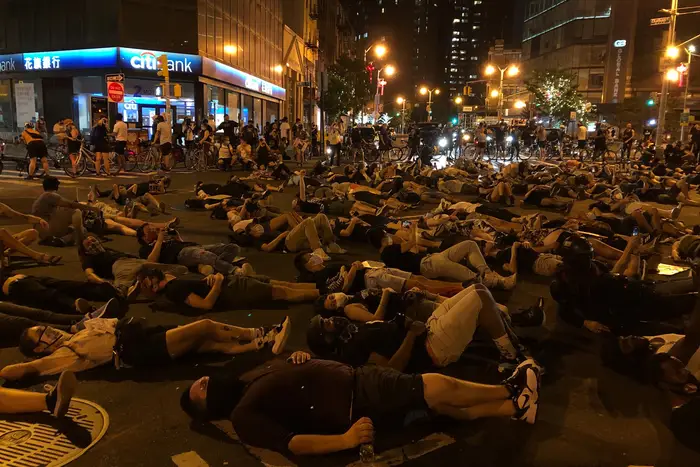 Protesters lie on the street, during the protest
